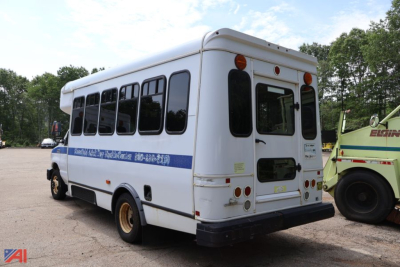 Ford E350 wheelchair bus rear left view showing blue stripe and wheelchair access area