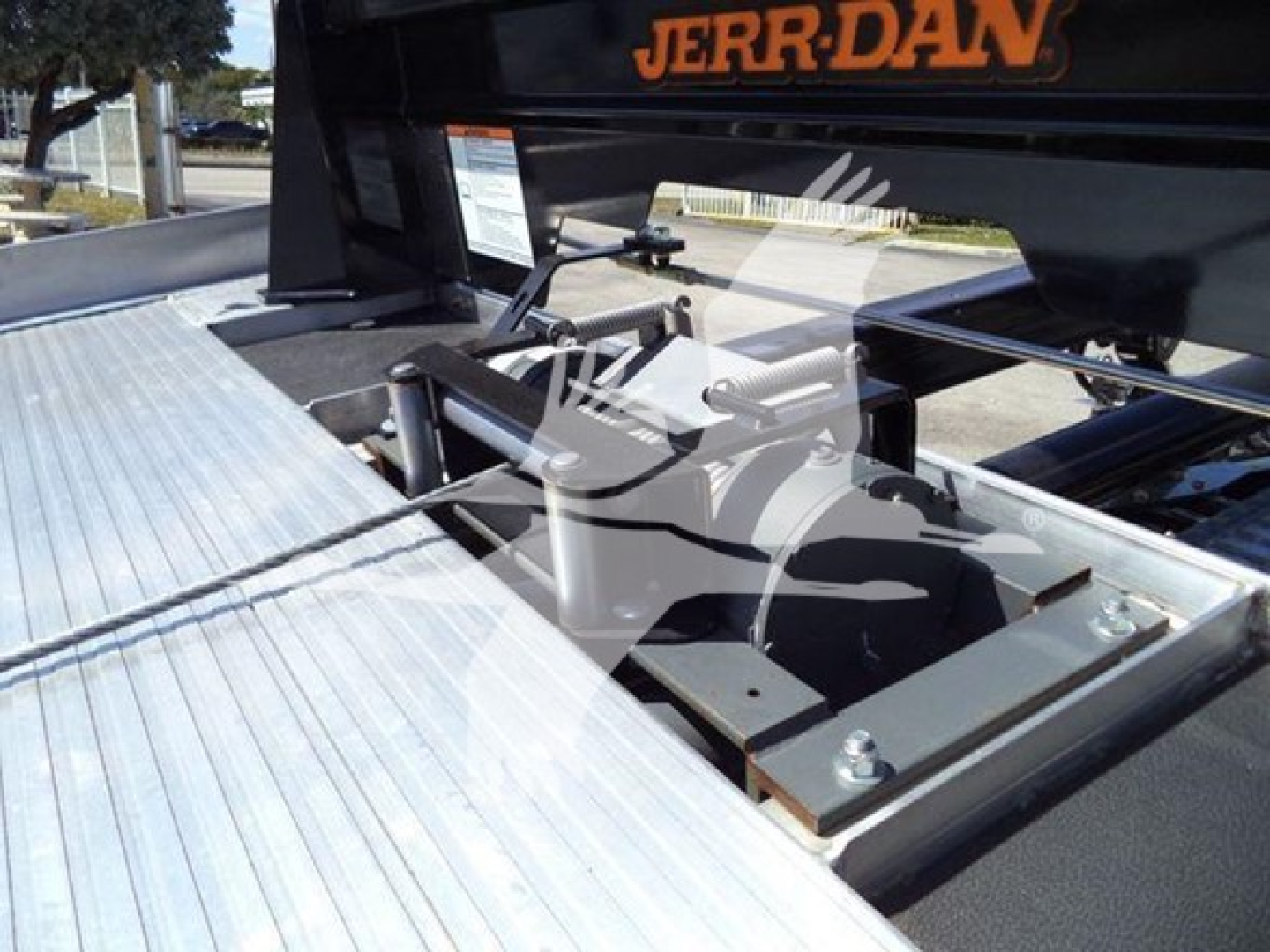 Ram Big Horn 2026 truck rollback module showing mounting hardware and hydraulic rigging with Jerr-Dan branding.