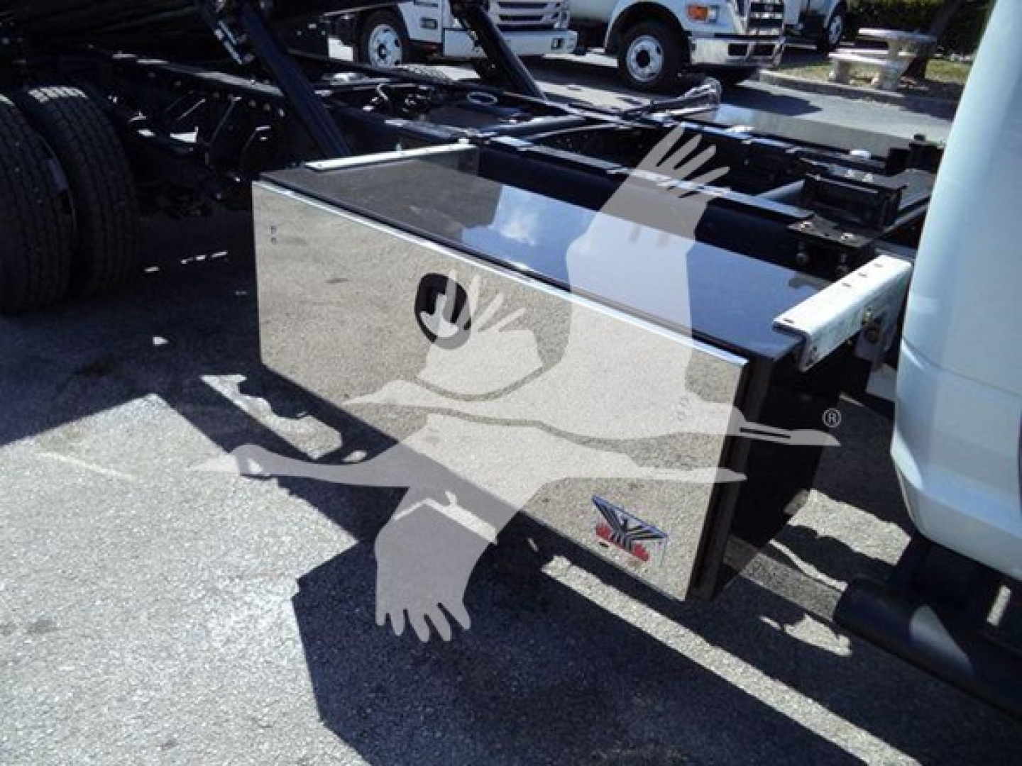 Ram Big Horn service body toolbox mounted on a rollback truck chassis with reflective metal toolbox.