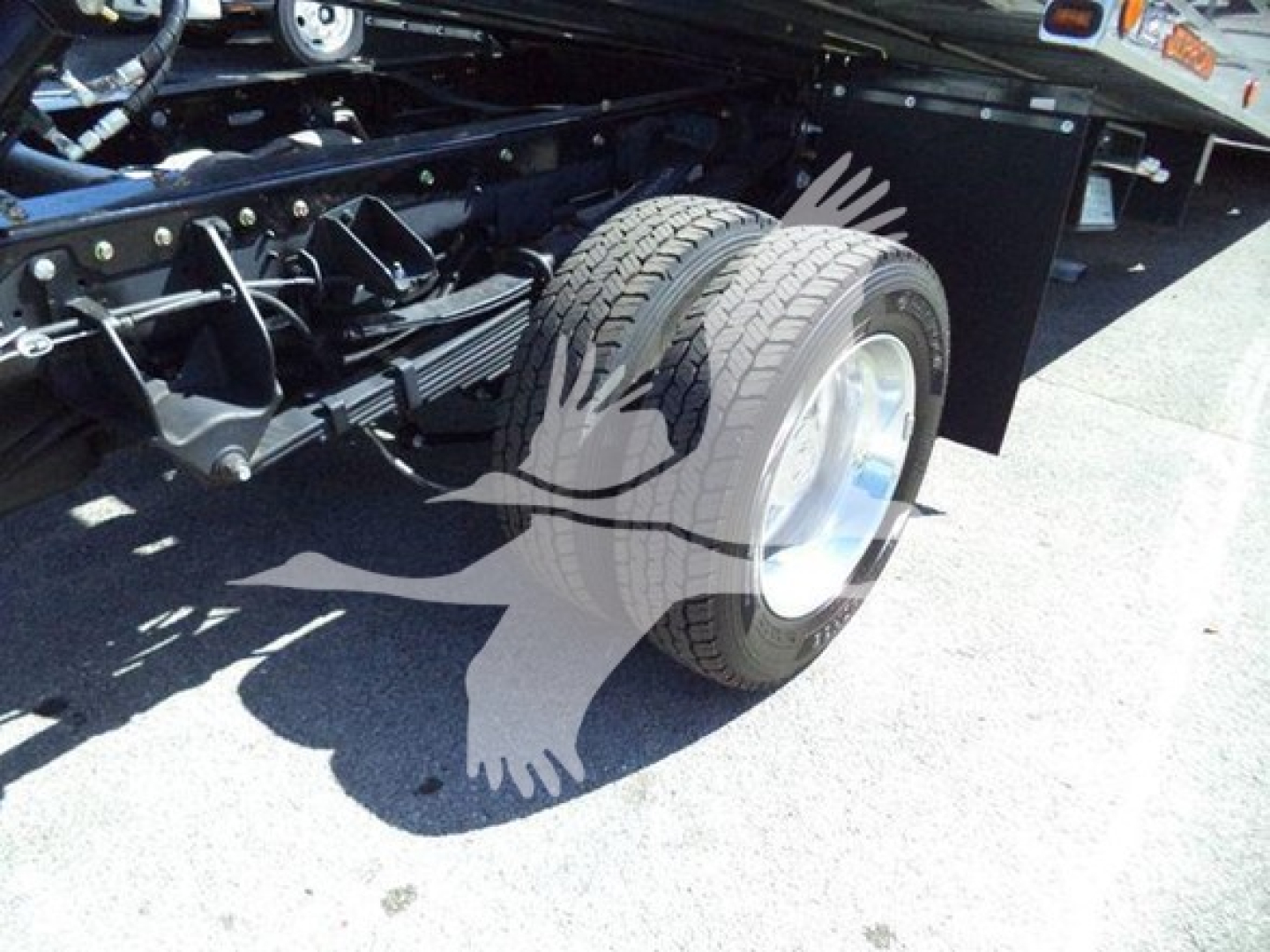 Truck chassis with rear wheel and suspension visible; no readable labels in the photo.
