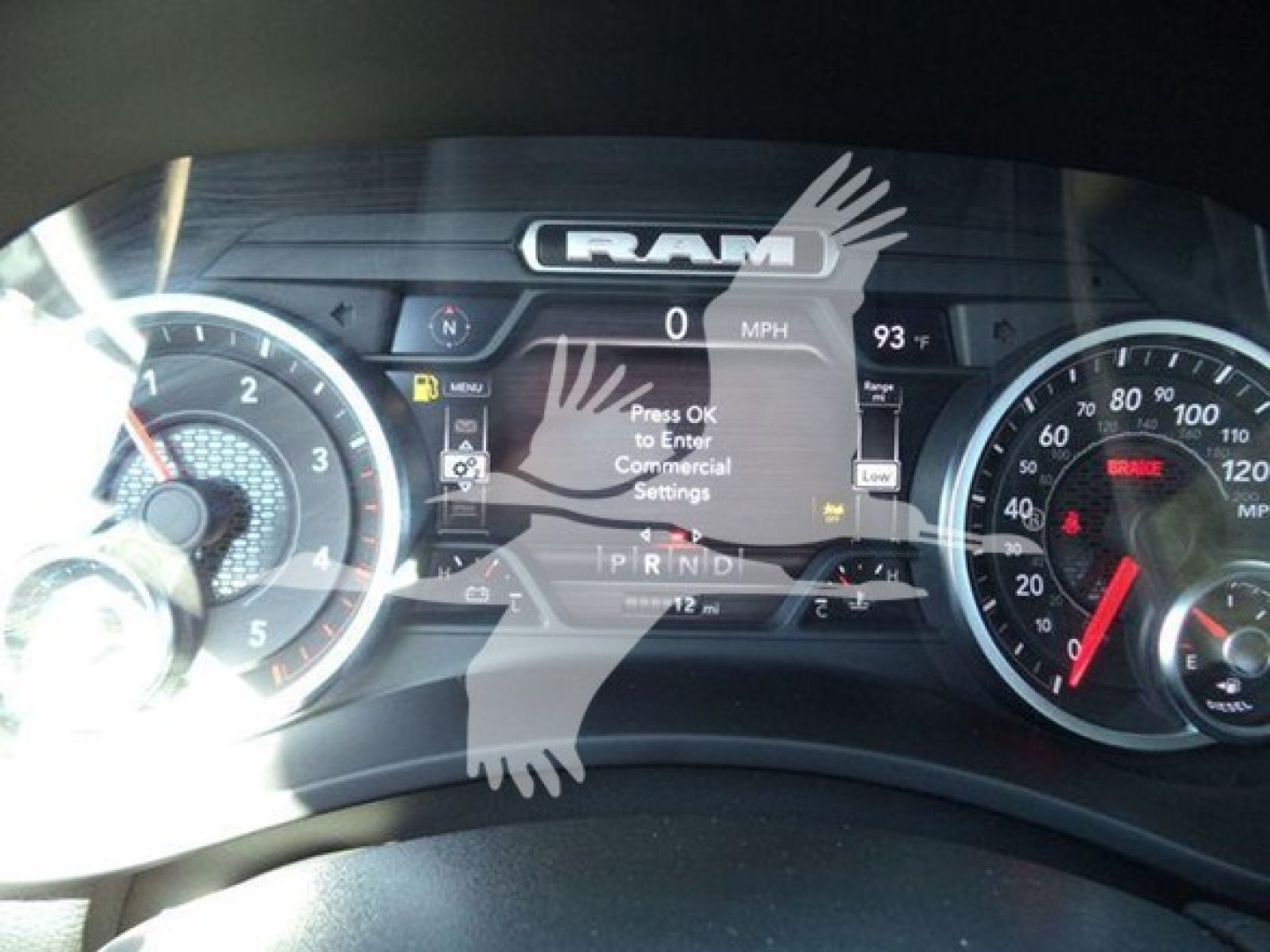 Dashboard of a Ram truck showing the instrument cluster with the RAM logo, speedometer, and digital display, plus various gauges and warning icons.