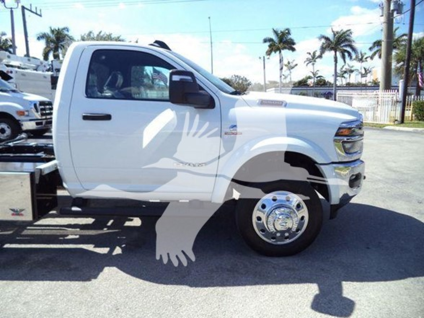 Truck side view showing RAM 4500 or 5500 style heavy-duty truck with rollback equipment and white cab