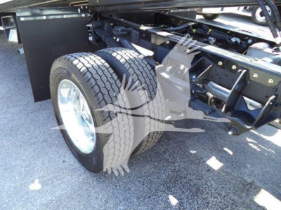 Truck chassis and dual rear wheels of a Ram 2026 Big Horn rollback showing dual tires and frame components.