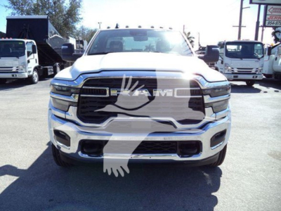 Front view of a white 2026 Ram Big Horn truck showing RAM grille and headlights
