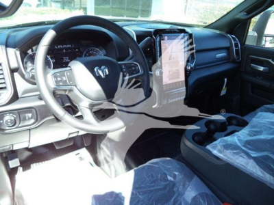 Ram pickup interior showing steering wheel and large center touchscreen display from driver seat view.