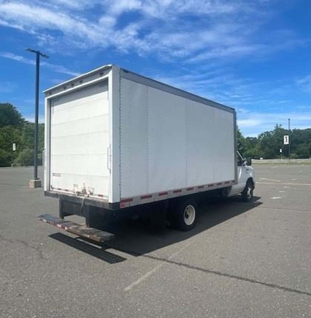 Ford E-Series Cutaway box truck rear and side view with cargo box, white with rear lift gate in lowered position.