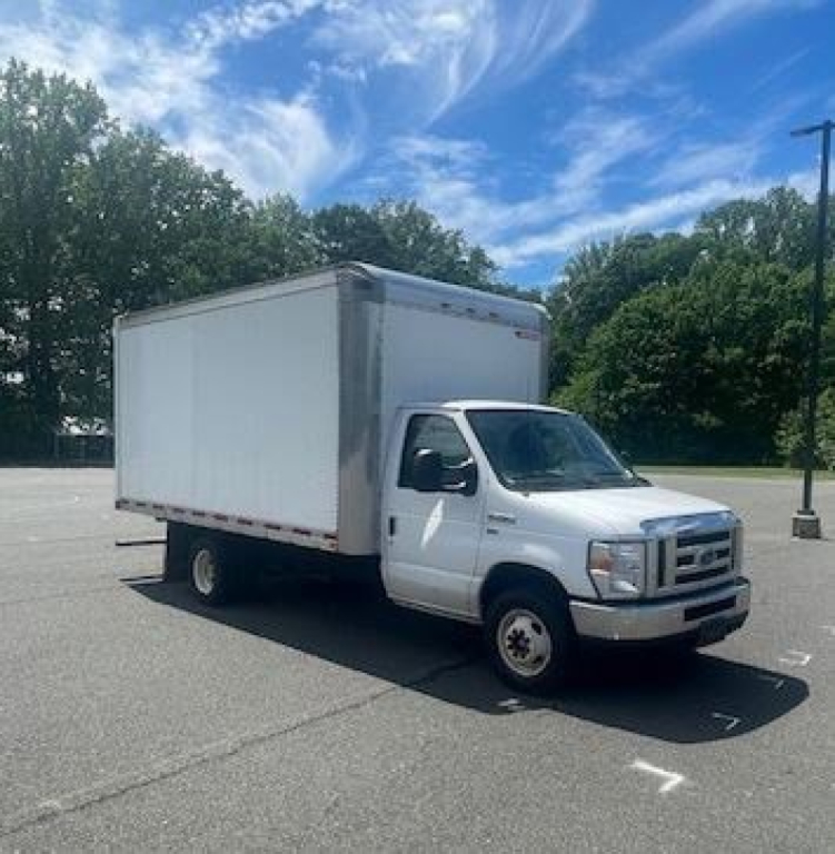 Ford E-Series Cutaway box truck in a parking lot showing a white cab and large box cargo area.