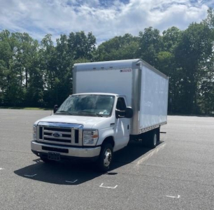 Ford E-Series Cutaway box truck in a parking lot showing cab and cargo box with white exterior and black grille; front view with Ford emblem.