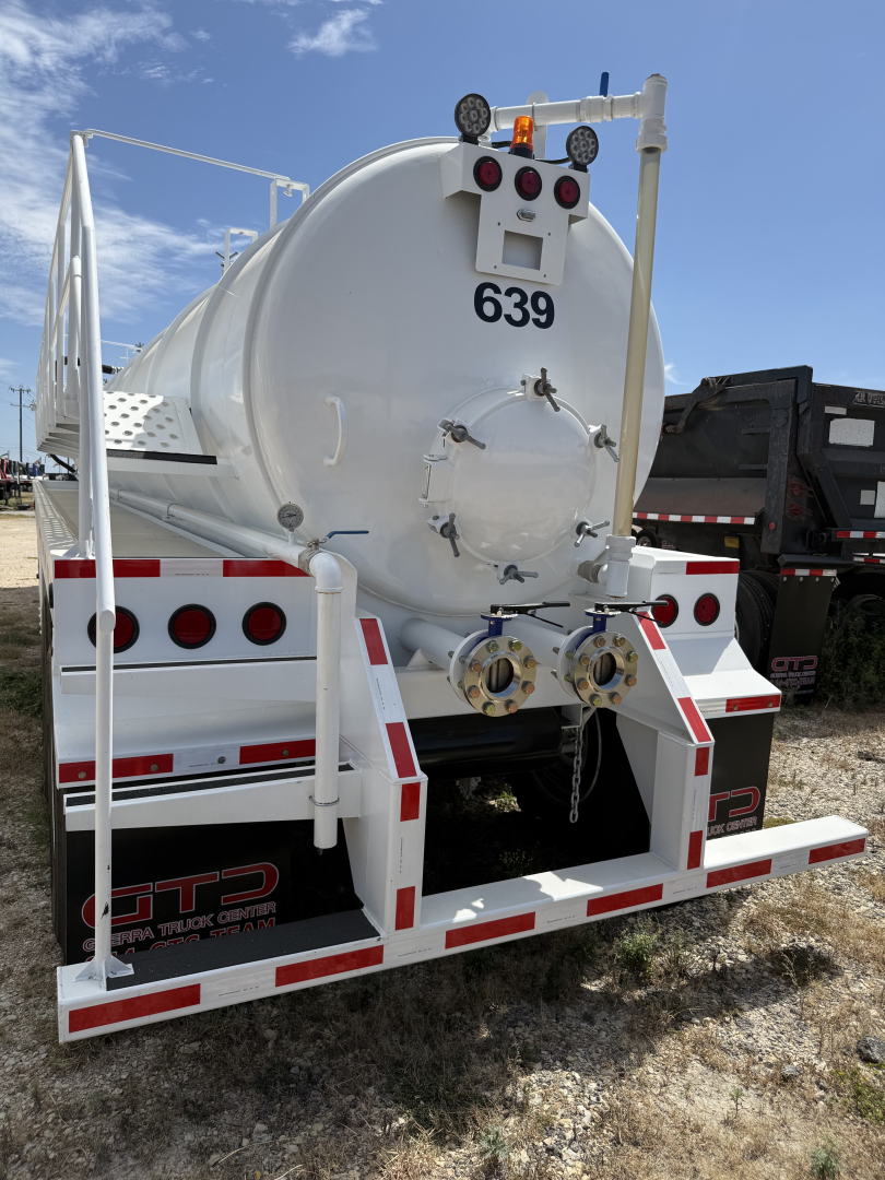 Back of a white Iron Lite VAC130 tank trailer showing rear doors, circular tank hatch, and mounting hardware with the number 639 and taillights.