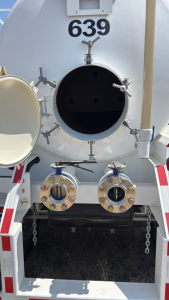 Tank rear showing large circular hatch and two circular inlet/outlet valves with bolted flanges, number 639, and a vertical pipe on right side.