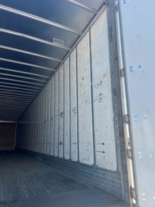 Interior of a used 2013 Utility Van trailer showing metal side walls and ribbed ceiling.
