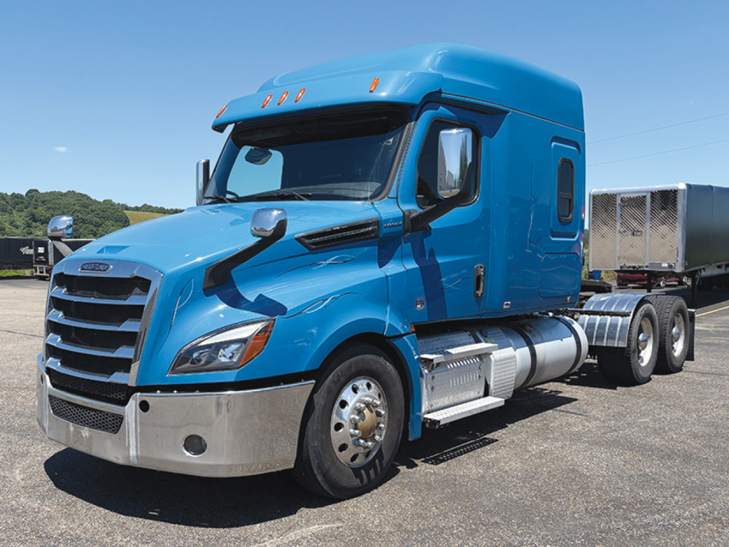 Blue Freightliner Cascadia126 conventional sleeper truck, front-left view, with chrome bumper and dual rear axles.