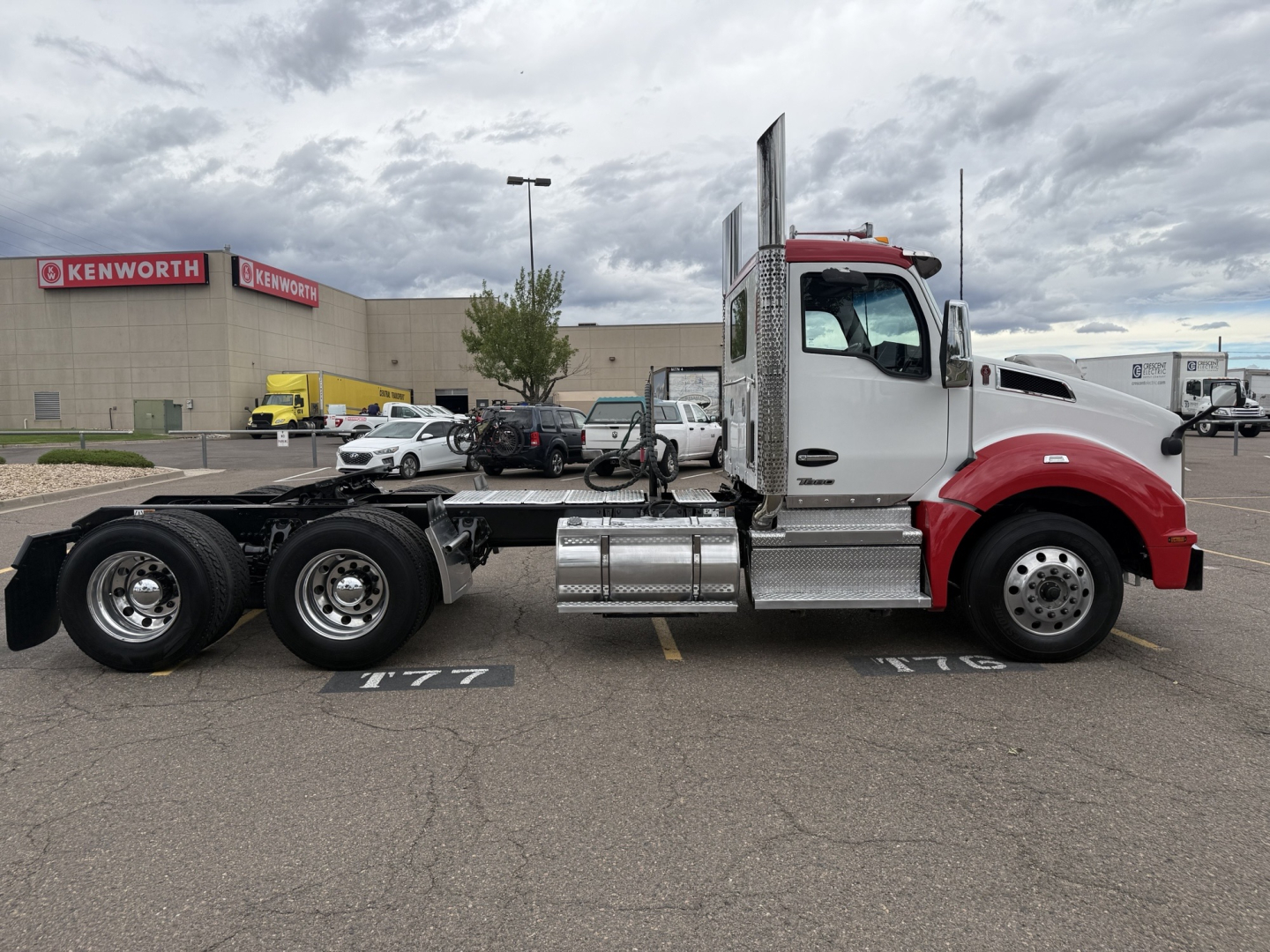 Kenworth T880 conventional daycab truck side view showing chassis, cab, and fuel tanks with chrome steps.