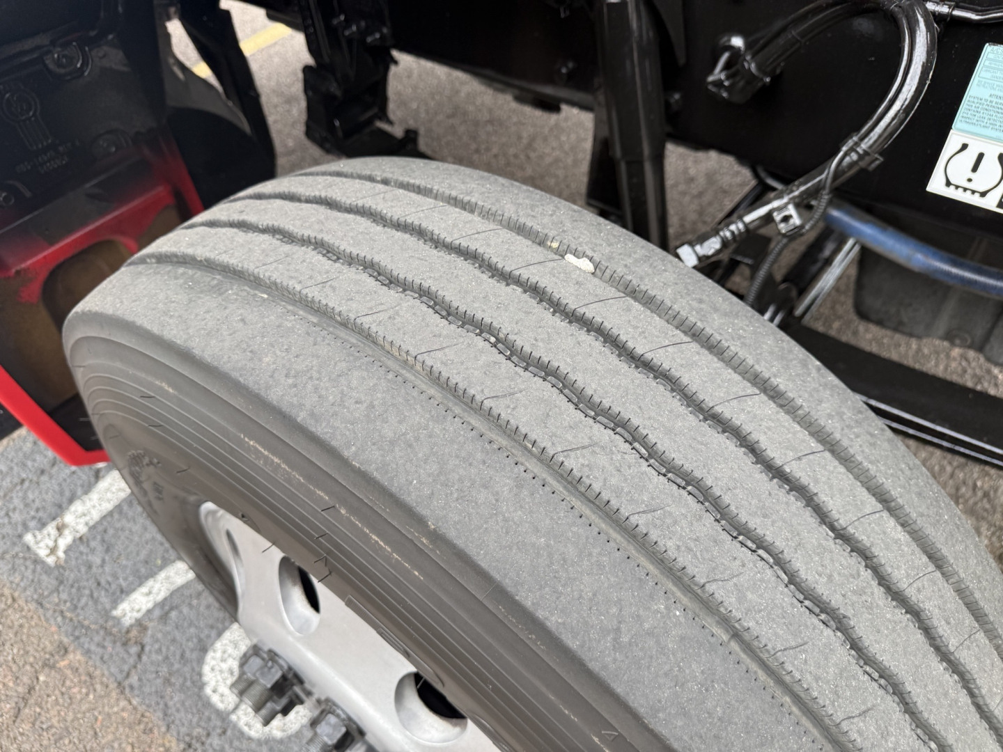 Tire tread close-up on Kenworth T880 chassis showing wheel and suspension area.
