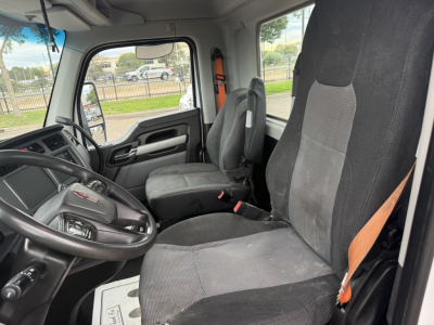Kenworth T880 truck interior showing driver and passenger seats, steering wheel, dash, and side window view.