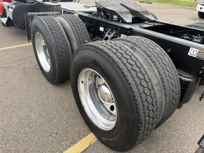 Kenworth T880 rear dual axle wheels and chassis showing tires and rims.