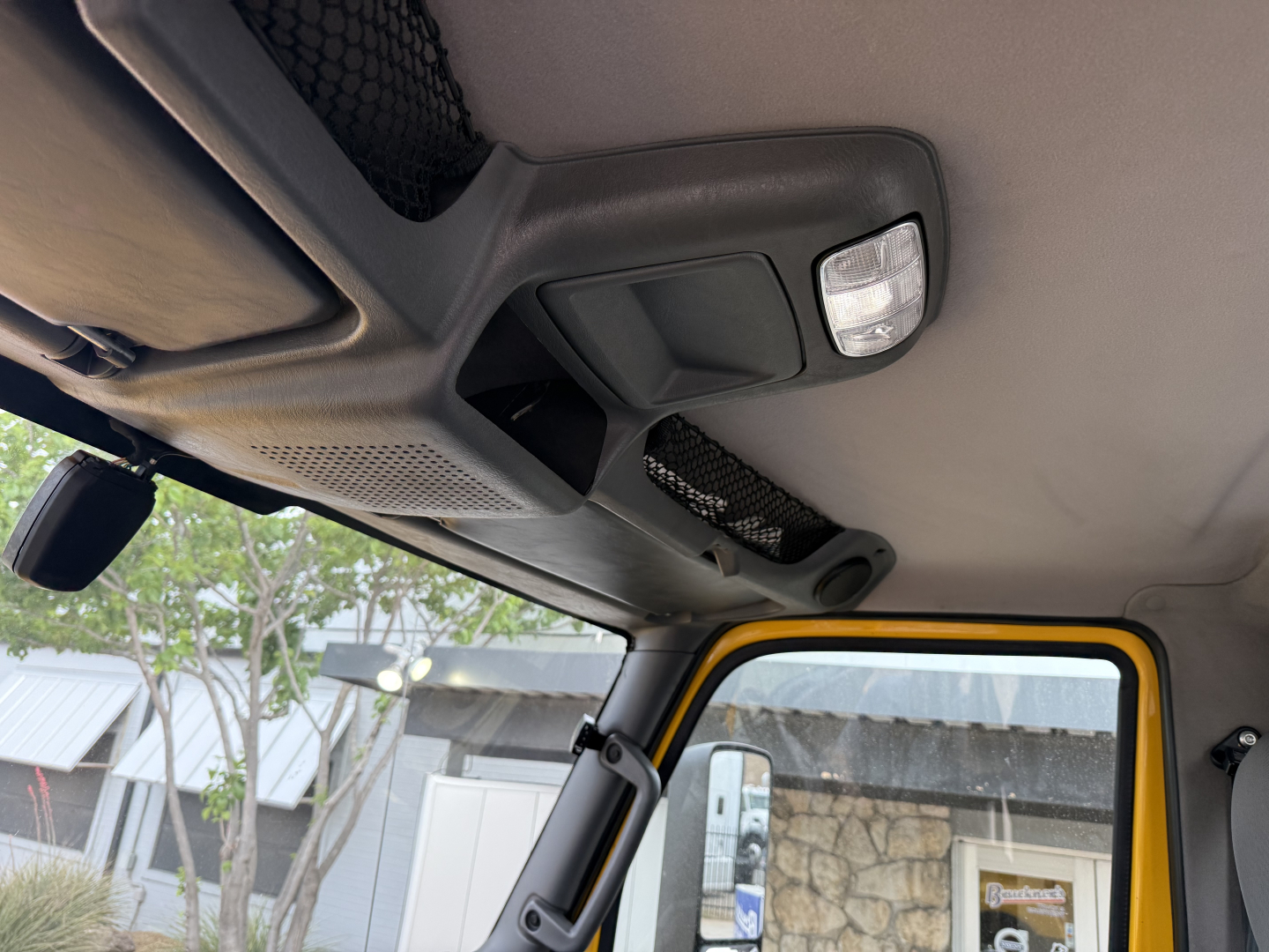 Cab interior of a 2019 International LT daycab showing overhead console and sun visor with cabin light.