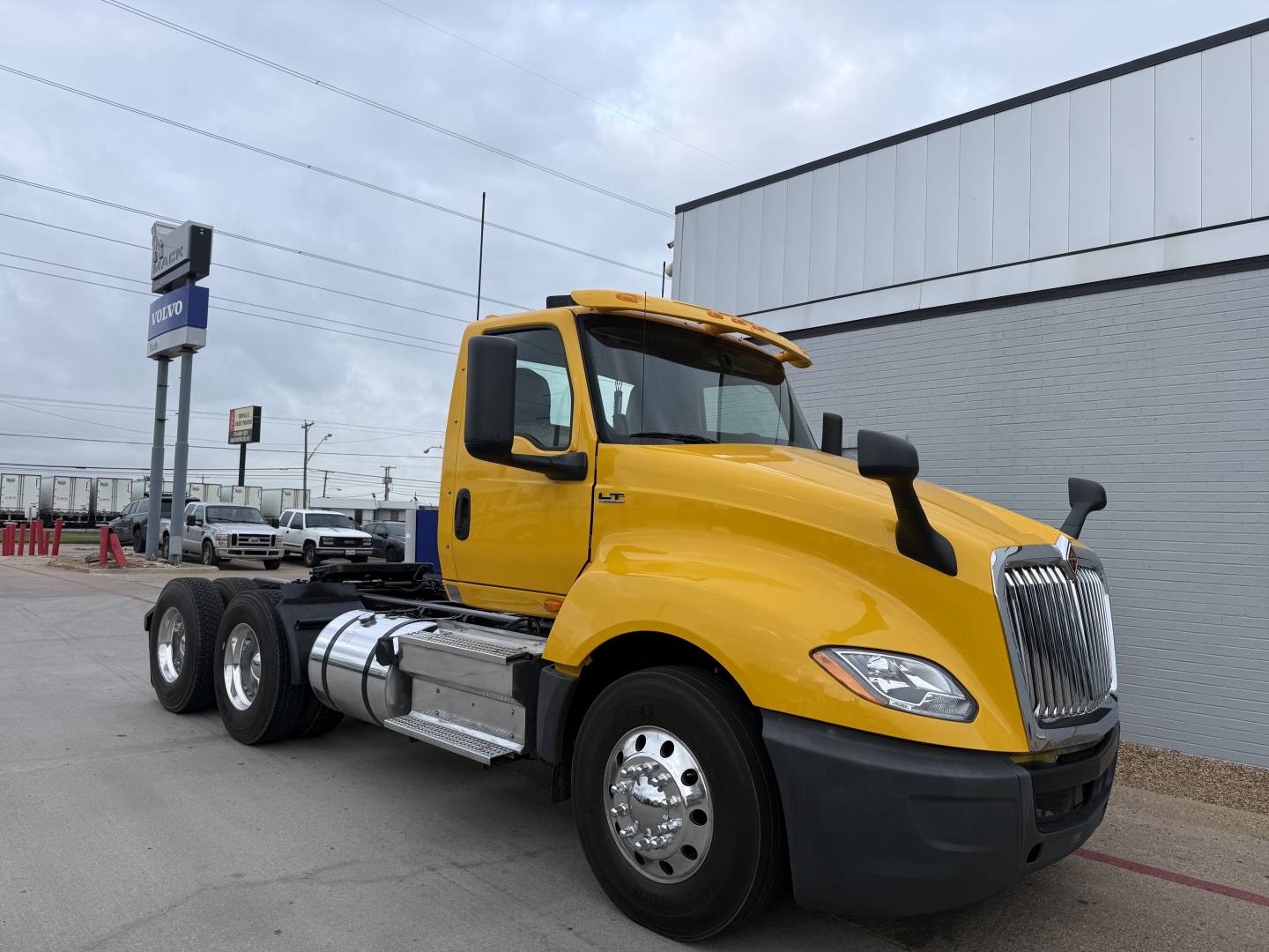 2019 International LT conventional daycab truck in yellow side view showing cab and front wheels with dual rear axles.