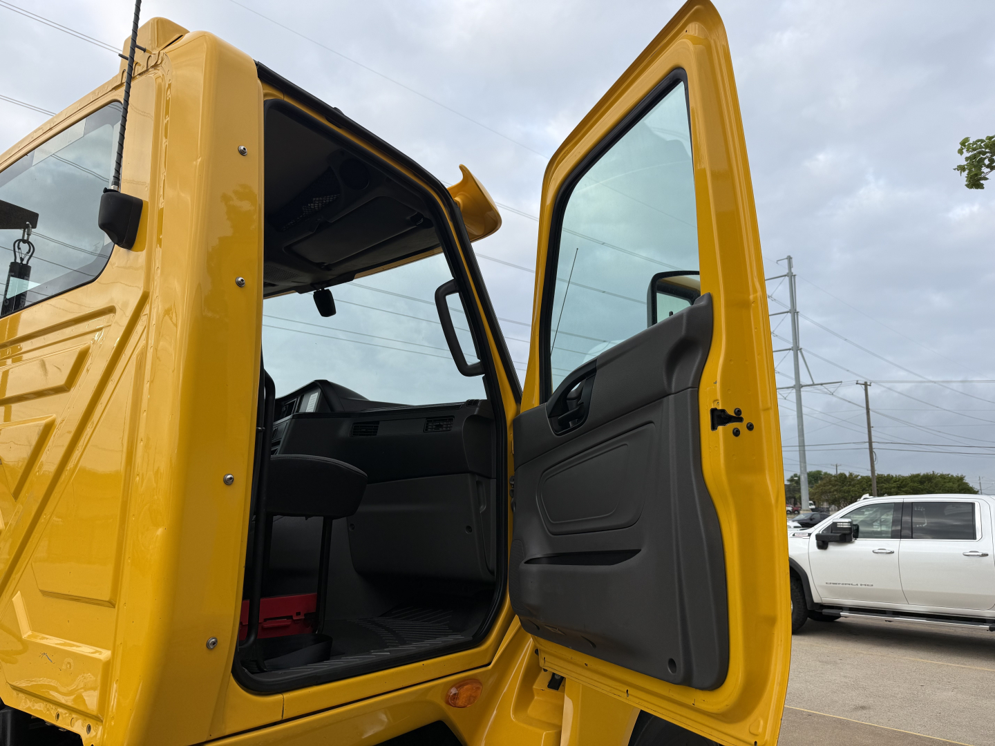 Truck cab interior and entry door of a yellow 2019 International LT Conventional Daycab showing open doors and cabin area.