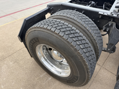 Two front dual tires of a 2019 International LT tractor, chrome wheel rims, heavy-duty dual tires on straight axle; part of a conventional daycab chassis.
