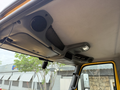 Cab interior overhead area of a 2019 International LT truck with ceiling grab handles, sun visor, and overhead speaker visible.