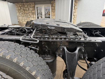 Truck chassis with fifth wheel and suspension components visible; mechanical frame and air lines show undercarriage of a used 2019 International LT.