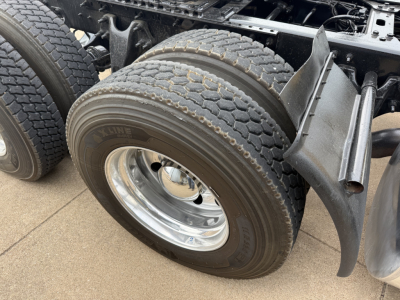 Truck rear dual tires and suspension on a 2019 International LT, axle area with dual tires and chrome wheel, visible frame and fender components.