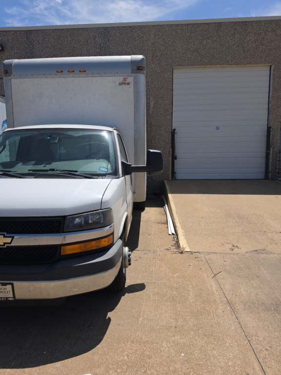 Chevrolet Express 3500 box truck front view showing cargo area and warehouse door.