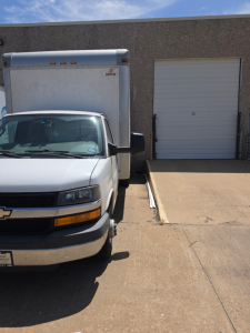 Chevrolet Express 3500 box truck front view showing cargo area and warehouse door.
