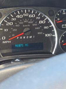 Dashboard of a Chevrolet Express 3500 showing speedometer up to 100 mph, odometer reading 9187 miles, and gear indicator PRNDM1.