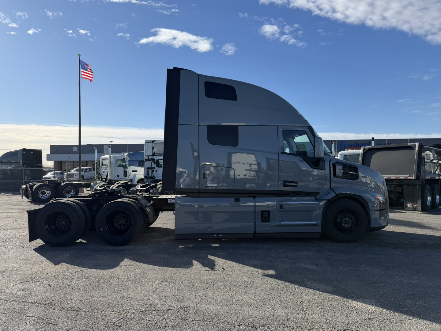 Truck side profile of a 2026 Mack PR64T76H conventional sleeper showing aerodynamic cab with raised roof and dual rear axles; VIN 1M1PR4GYXTM100899 on listing; stock 71776.