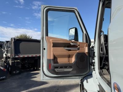 Truck cab door open showing interior panel and 'MACK' badge on lower door panel.