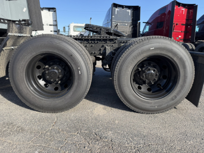 Dual rear truck wheels and chassis frame showing wheels and suspension components for a 2026 Mack PR64T76H tractor.