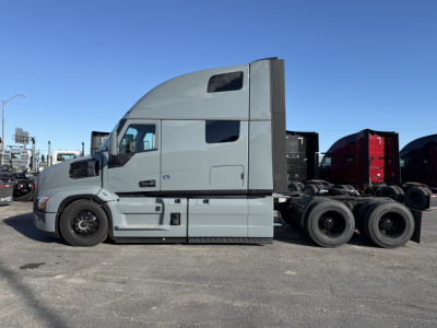 Mack PR64T76H conventional sleeper tractor shown in side profile with light gray cab and rear axles, no trailer attached.