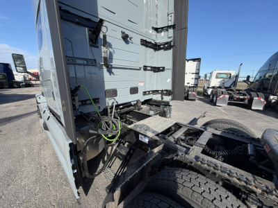 Truck cab and rear chassis of a Mack PR64T76H with fifth wheel and wiring harness visible in the sleeper cab area.