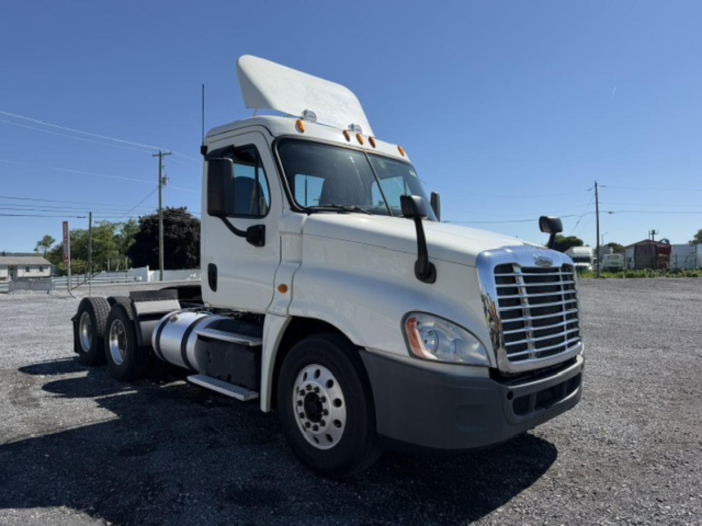 White Freightliner Cascadia semi-truck daycab with tall sleeper, six wheels, front grille, and side mirrors.