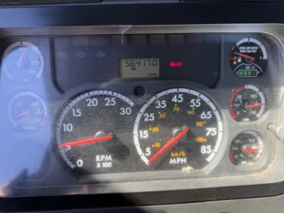 Dashboard cluster of a Freightliner Cascadia cab displaying RPM gauge, speedometer, and various indicator lights.