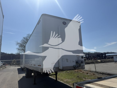 Trailer rear view showing large white Great Dane Pup logo on the back of a white 2018 Pup trailer, with VIN 1GRAA5611JB702094 and stock number 7652 visible.