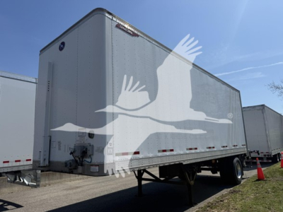Great Dane Pup trailer side view showing tandem axle and front hitch area with stock number 7652