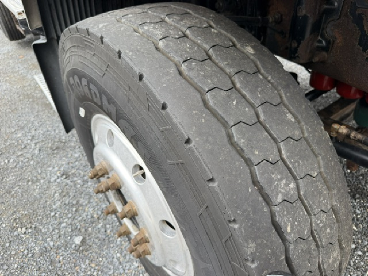 Volvo heavy-duty truck wheel and tire with lug nuts visible and tread pattern.