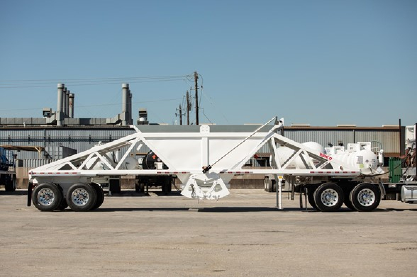 Ranco Wet Sand Switchgate Bottom Dump trailer shown in side view with white frame and tri-axle configuration.