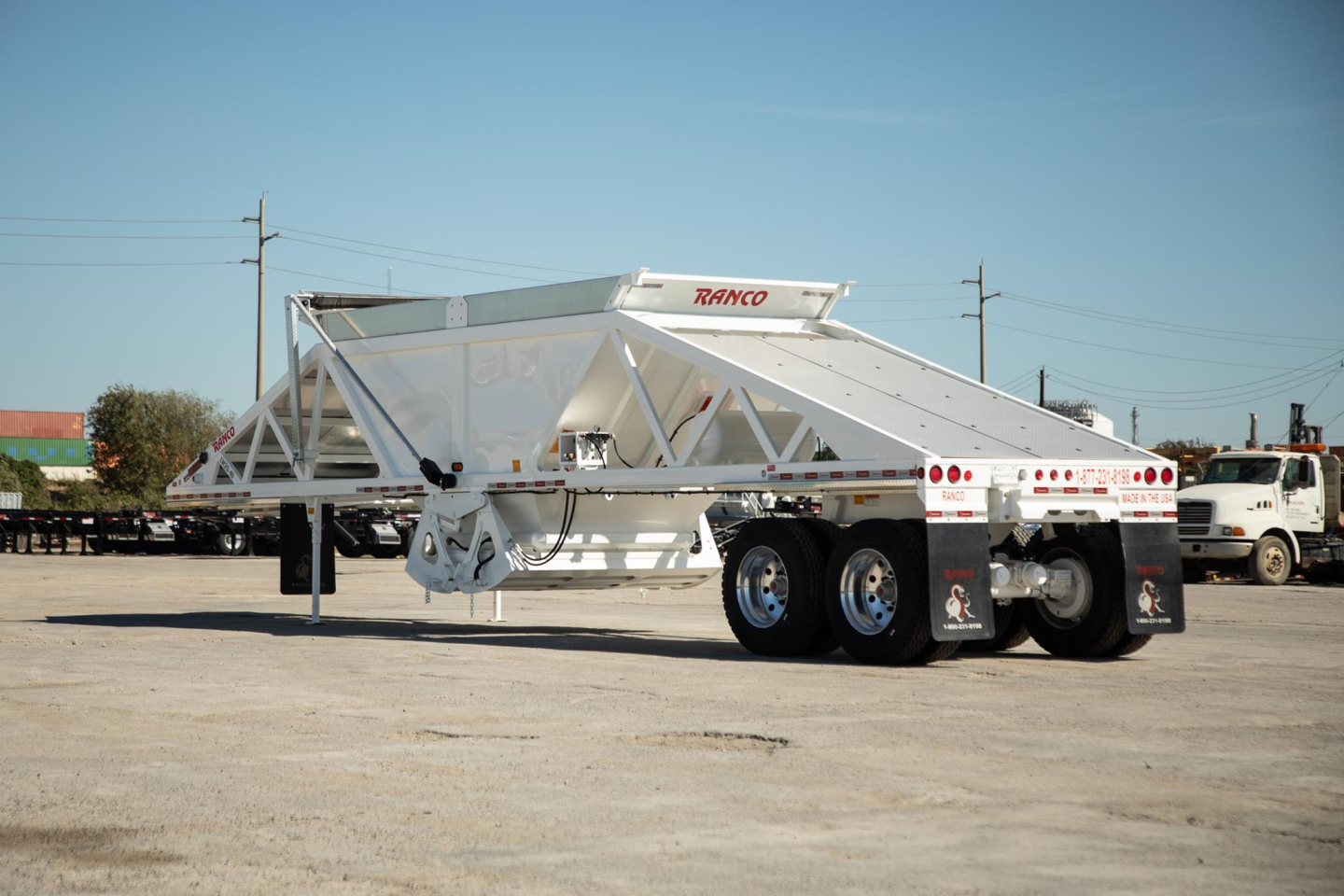 Ranco wet sand switchgate bottom dump trailer in white with dual rear axles and long body