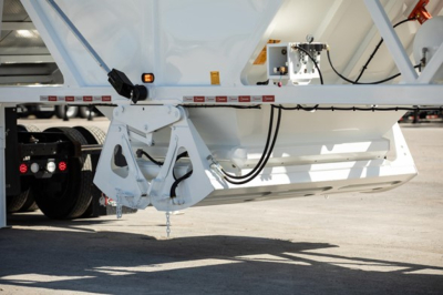 Trailer hitch and underside of a 2026 Ranco Wet Sand Switchgate Bottom Dump showing hydraulic lines and mounting hardware.