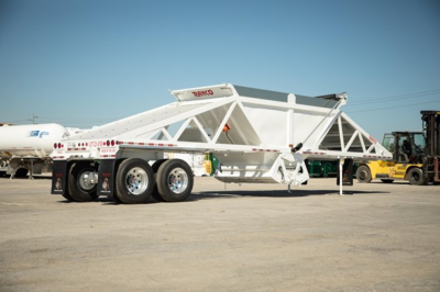 Ranco Wet Sand Switchgate Bottom Dump trailer in white, side view showing Tri-axle rear with wheels and elevated bottom-dump bed, label near front.