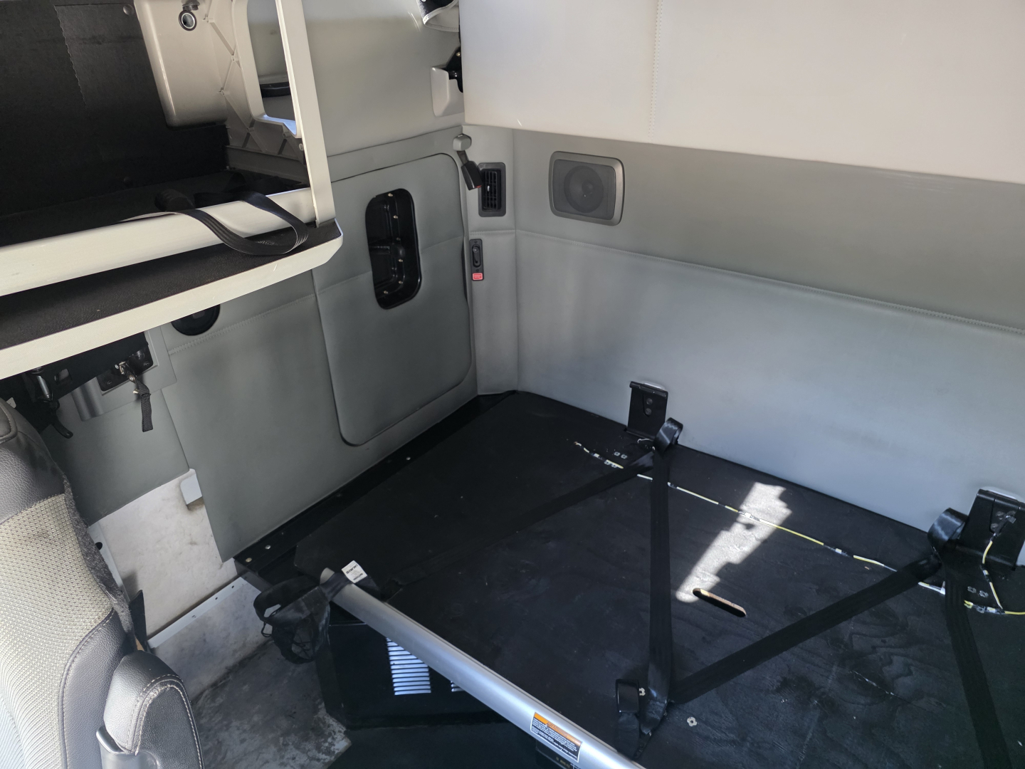 Kenworth T680 interior cargo area with seating area and cargo straps visible, 2022 model, VIN 1XKYD49X9NJ485551, stock 0632032.