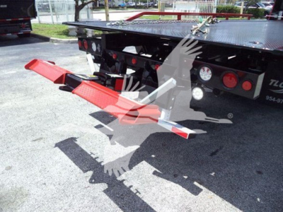 Hino 268A rollback truck rear with red fold-out ramp in view and hydraulic lines visible.
