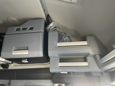 Cab interior storage drawers and side cabinets in a 2026 Mack PR64T76H sleeper truck showing grey plastic drawers and compartments.