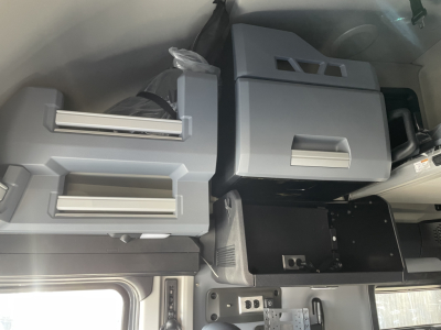 Cab interior of a Mack PR64T76H truck showing storage compartments and dashboard area with grey/blue abundant panels.