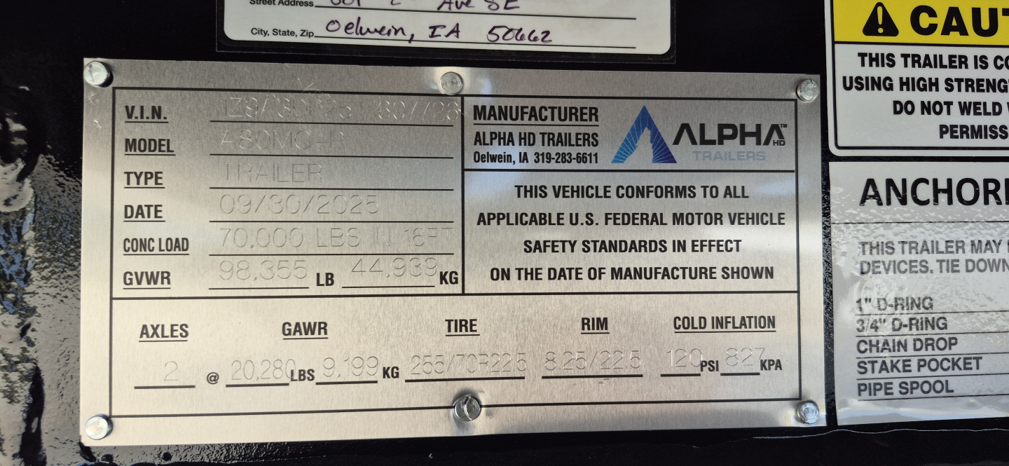 Trailer identification plate showing VIN 1Z9A3DP25T1607726, model, type as trailer, date 09/30/2023, GVWR 36,000 LB, GAWR 12,000 LB per axle, manufacturer Alpha HD Trailers with logo, and label about compliance and tires.