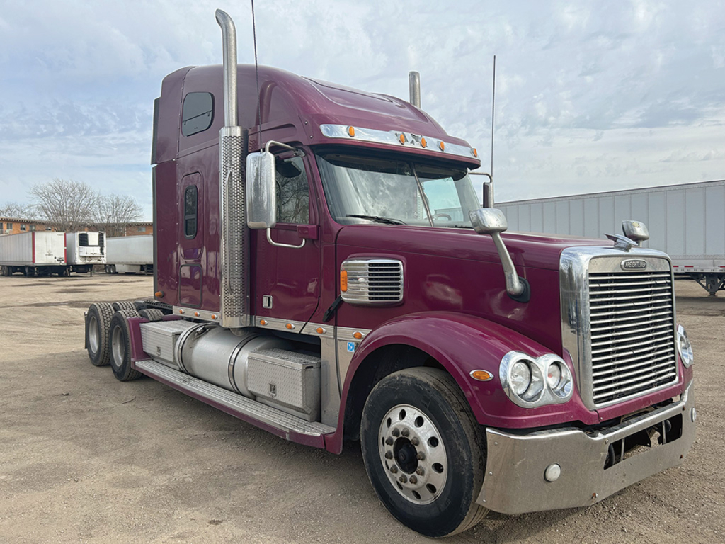 Tractor head of a maroon 2020 Freightliner Coronado conventional sleeper truck with chrome bumper, dual exhaust stacks, and day cab windows.